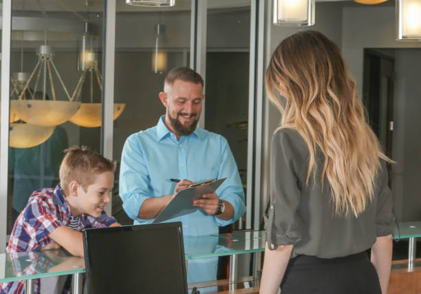 istock Man being helped in doctors office with son 863826006