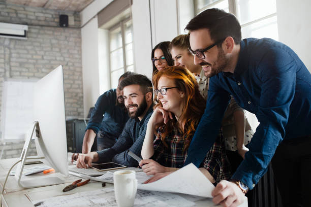 istock Group of young designers working as team 863826092