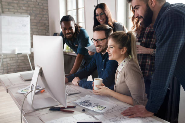 istock Group of young designers working as team 863826178