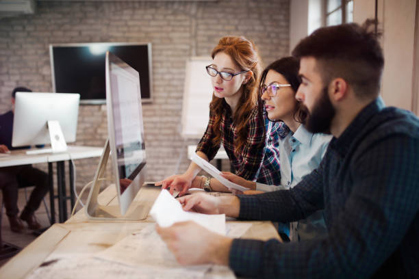 istock Group of young designers working as team 863826476