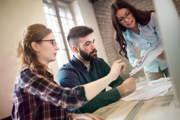 istock Group of young designers working as team 863826592