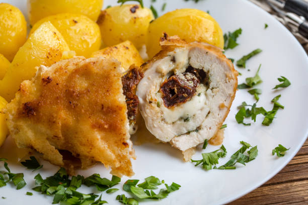 Baked chicken breast stuffed with cheese and dried tomatoes served with boiled potatoes.