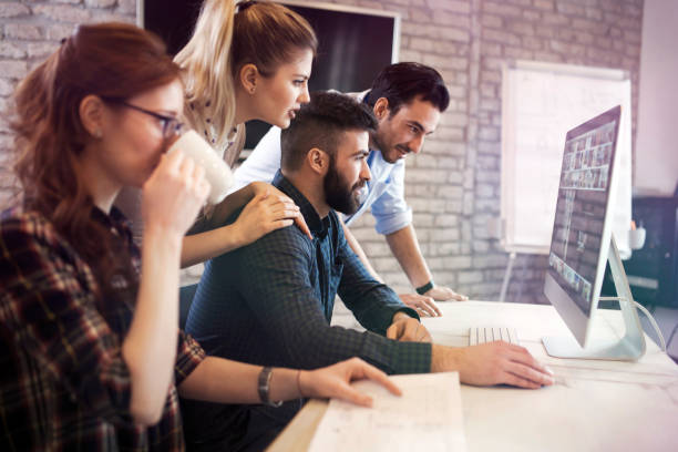 istock Group of young designers working as team 863829074