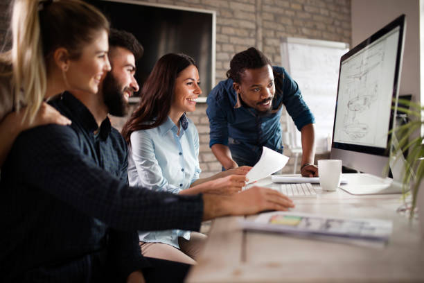 istock Group of young designers working as team 863829598