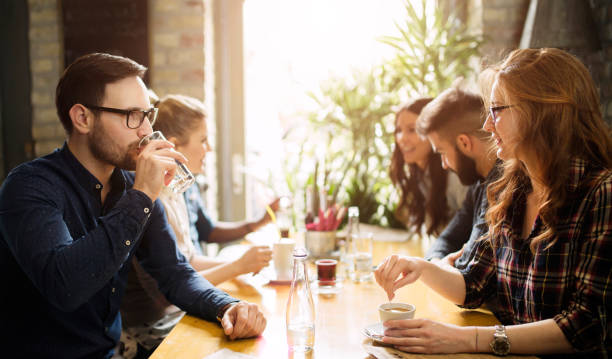 istock Happy colleagues from work socializing in restaurant 863829892