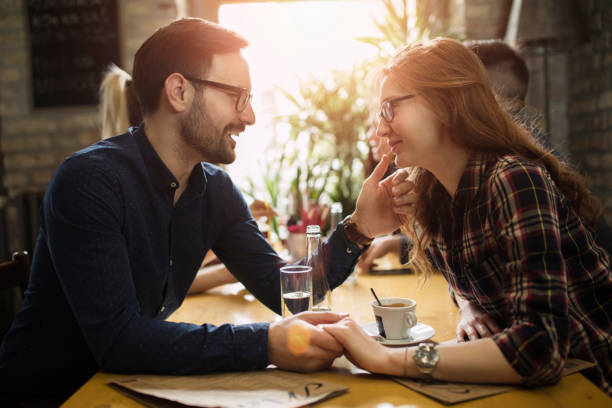 istock Handsome man flirting with cute woman in restaurant 863829940