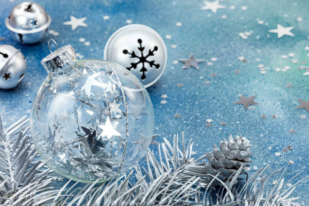 istock christmas glass ball and silver jingle bells on blue background 863832586