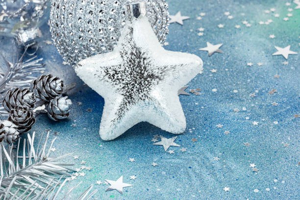 istock silver christmas decorations and fir cones on blue background 863833272