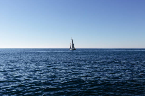 istock Luxury yacht with white sails sailing in clear blue water 863838948