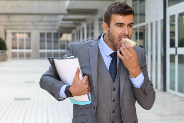 istock Businessman walking and eating at same time 863839770