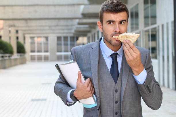 istock Businessman walking and eating at the office 863839772