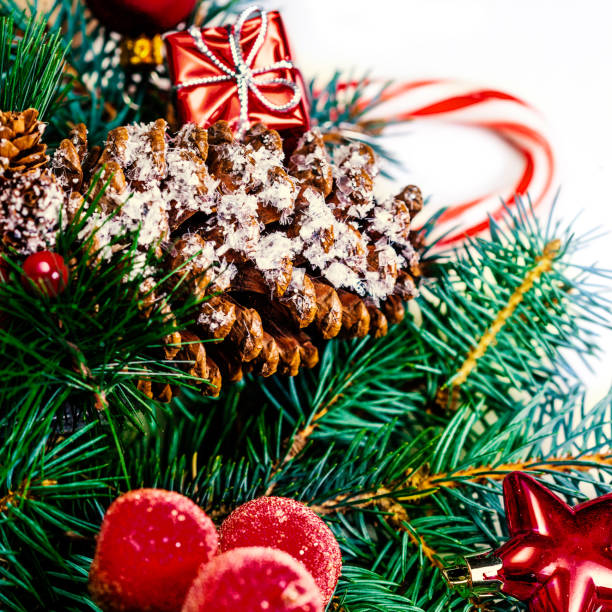 istock Christmas or New Year decorations background with pine cones, fir branches and gift boxes isolated on white. Vintage Merry Christmas  Card 863843320