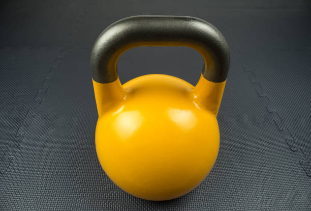 istock Yellow competition kettlebell on a gym floor 863845570