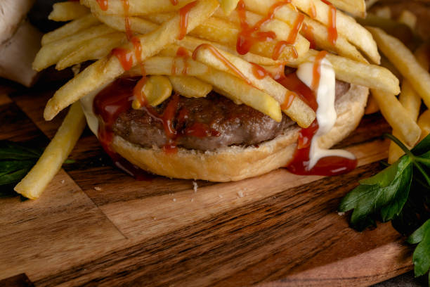 istock Grilled beef burger on a wooden plate 863845700