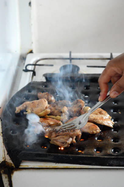 istock Grilled chicken on a barbecue grill on a gas fire 863857120