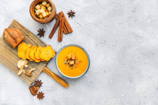 Bowl with sweet potato soup and spices. Flat lay styling Bowl with sweet potato soup and spices. Flat lay styling squash soup stock pictures, royalty-free photos & images