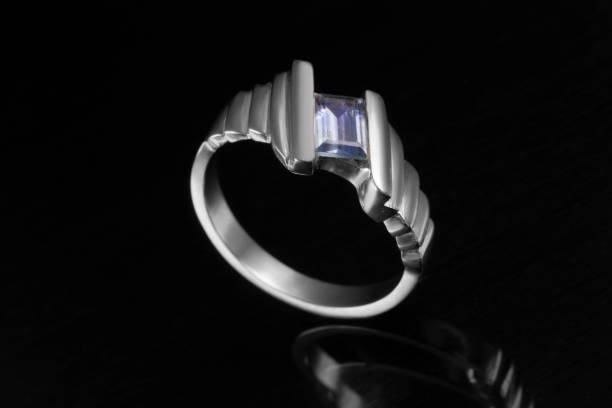 istock ring in gold with gemstone and  diamonds  in black background 863864960