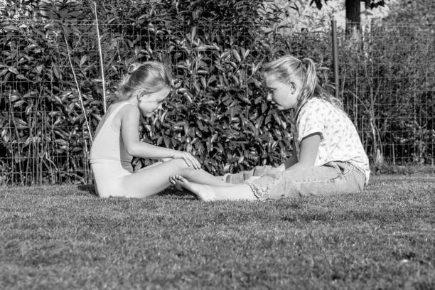 istock Blonde sisters doing ballet exercises in the garden 863880478