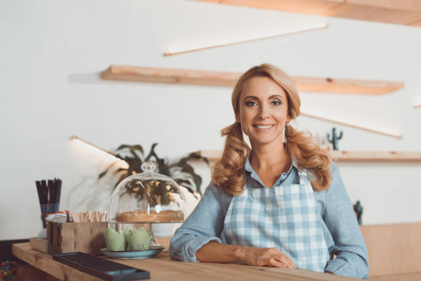 istock beautiful cafe owner in apron 863889604