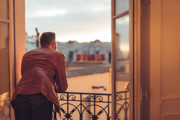 istock Bearded man looking out over the city at sunrise 863889784