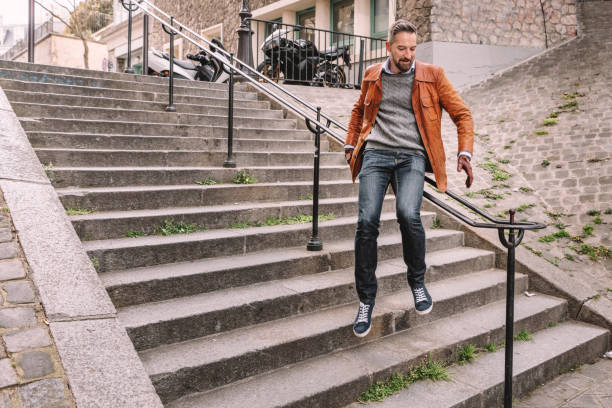 Young man in Montmatre, Paris sliding down the balustrade