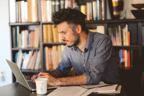 istock Young man reading and working at home 863890006