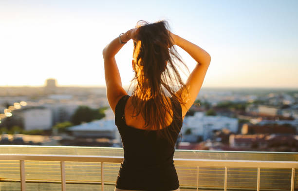 istock Young woman enjoying the balcony view 863890482