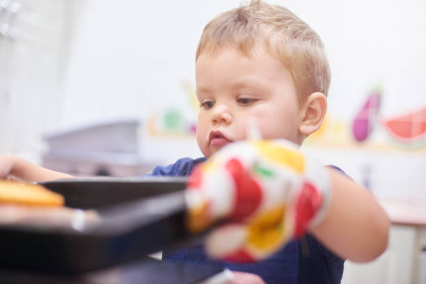 Toddler interacting with toys and educational equipment at nursery or children’s museum