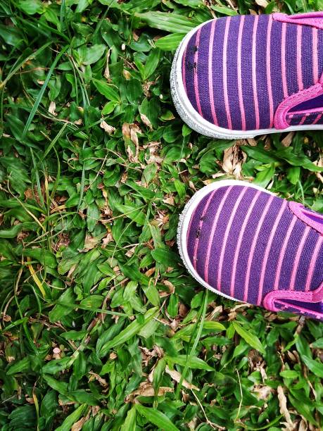 istock Baby Shoes at Fresh Green Grass 863925026