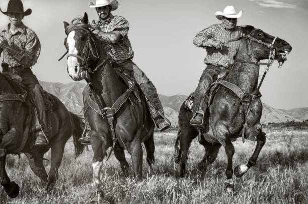 istock Three Tough Riding Cowboys Coming In Hard and Strong  On Their Approach 863925370