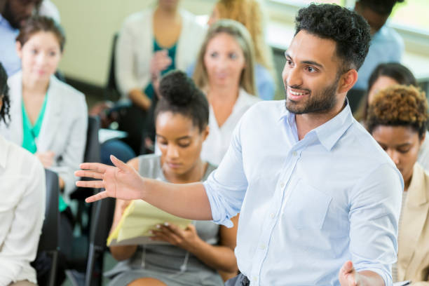 istock Young male business graduate student lectures undergraduate students 863958414