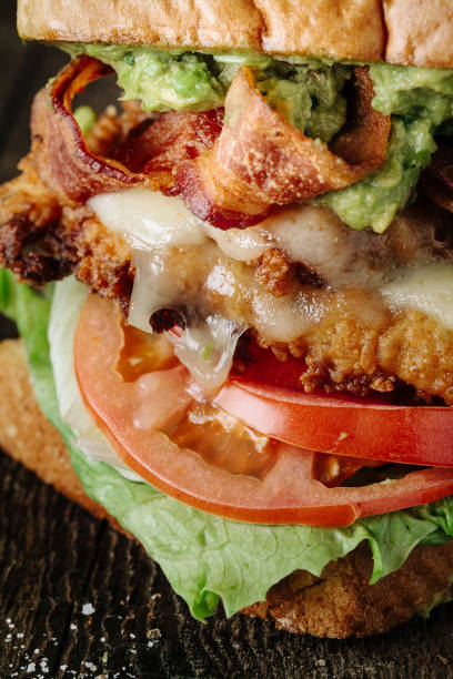 istock BLT sandwich with chicken and avocado on rustic background, close up 863972882