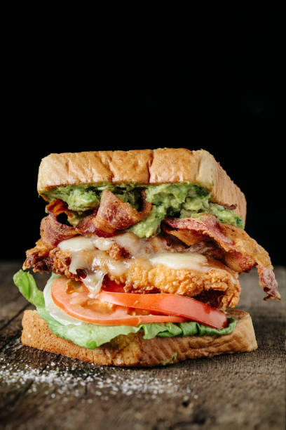 istock BLT sandwich with chicken and avocado on rustic background 863972894