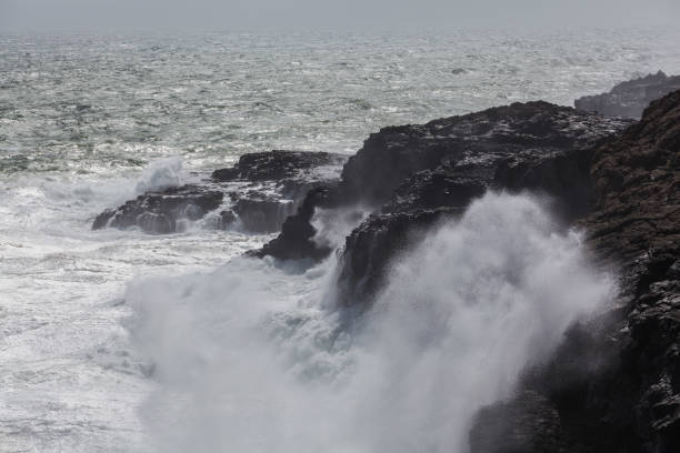 istock Waves breaking hard on rocks - extreme force of nature 863990890