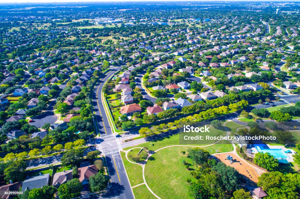 Round Rock , Texas , USA aerial drone view high above Suburb Neighborhood at park Homes Round Rock , Texas , USA aerial drone view high above Suburb Neighborhood with Vast amount of Homes - Summertime in the best place to live in America - at all way stop or crossroads Community Stock Photo