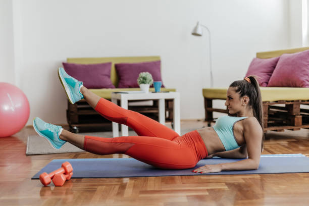 istock Young woman doing abs exercise in her living room 863991218