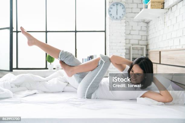 Asian Women Exercising In Bed In The Morning She Feels Refreshed Stock Photo - Download Image Now