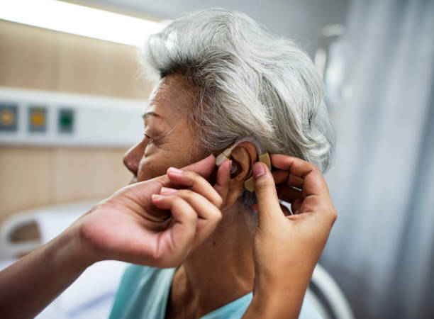 istock Asian old woman having her ears checked 864010098