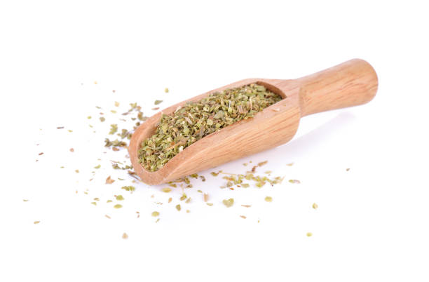 istock dry oregano leaves on bamboo spoon and on white background 864012450