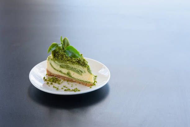 istock piece of green tea cake in white dish serve on black table 864018100