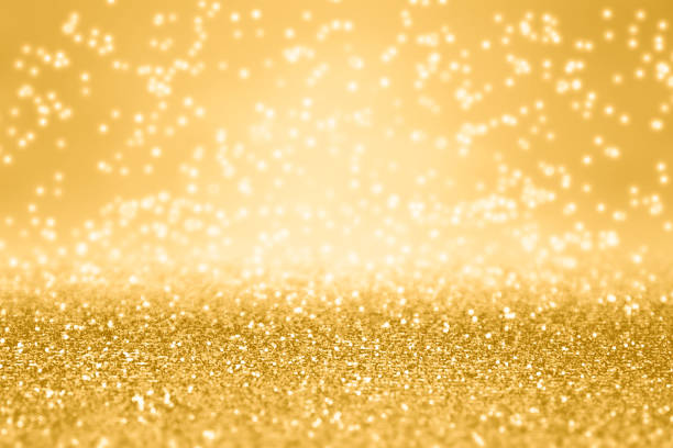 Fancy Gold Glitter Sparkle Background For Anniversary, Christmas or Birthday Elegant gold glitter sparkle confetti background for golden happy birthday party invite, 50th anniversary, New Year’s Eve champagne backdrop, glitzy falling diamonds, Christmas or wedding luxury sparkly pattern 50th anniversary photos stock pictures, royalty-free photos & images