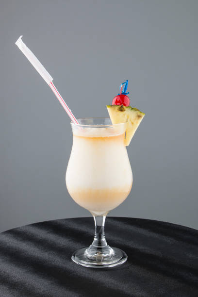 istock Fresh pineapple cocktail with cherry and organic pineapple slice on gray background 864034896