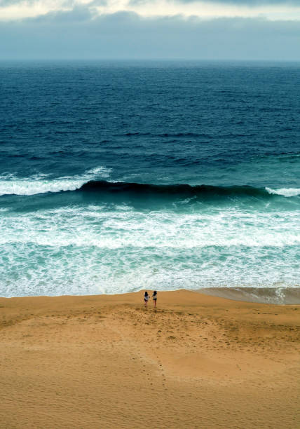 istock Women running to Pacific Ocean, Pacifica, California 864035252
