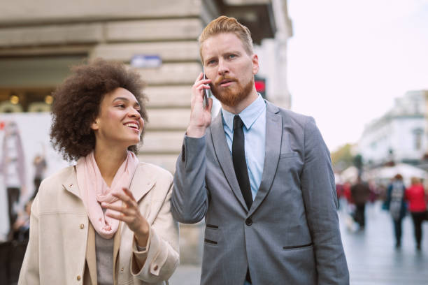 istock Happy business couple using smart phone outdoors 864049442