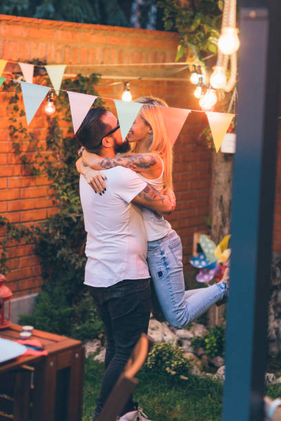 istock Tattooed Couple Having Fun At Barbecue In Backyard 864053414