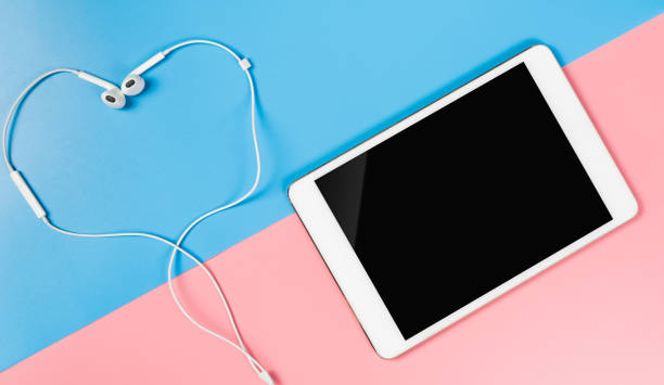 istock Empty Tablet screen with earphone on blue and pink for Music Concept 864057736