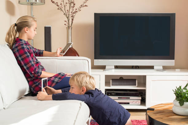 istock Children using tablet and smartphone in living room 864110658