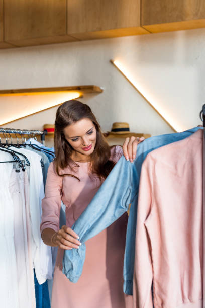 istock young woman choosing clothes in boutique 864118510