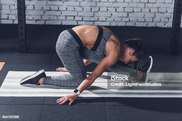 Woman Stretching On Mat Stock Photo - Download Image Now - Active Lifestyle, Adult, Adults Only