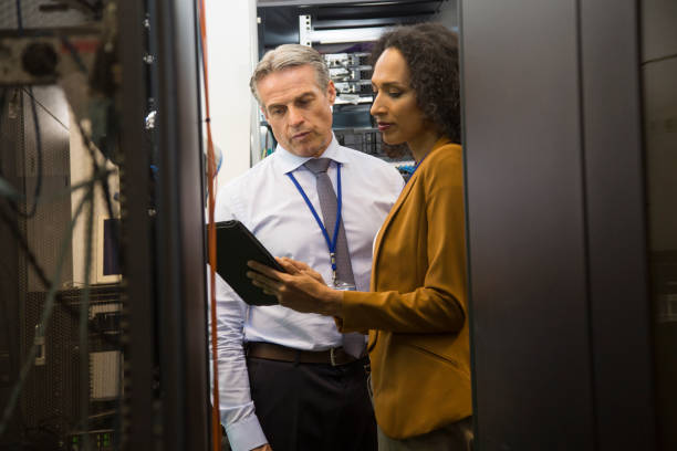 istock IT professionals having meeting in server room 864137818